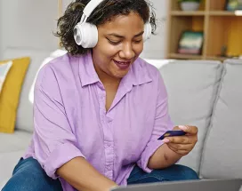 woman wearing headphones and shopping online